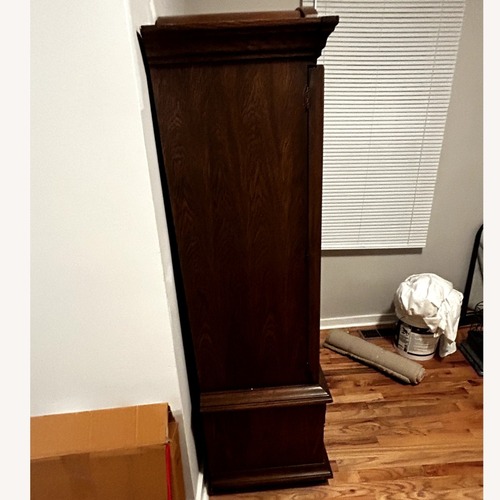 Used Vintage/Antique Dark Brown Solid Wood Armoire for sale on AptDeco