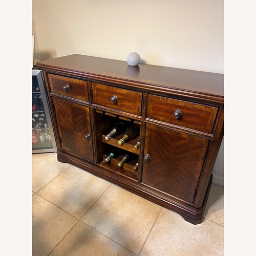 Used Rooms To Go Dark Brown Wood Wall Unit for sale on AptDeco