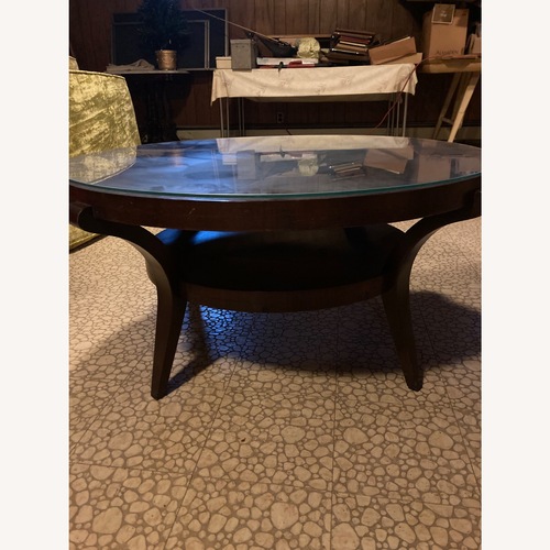 Used Round Brown Wood Coffee Table w Glass Top for sale on AptDeco