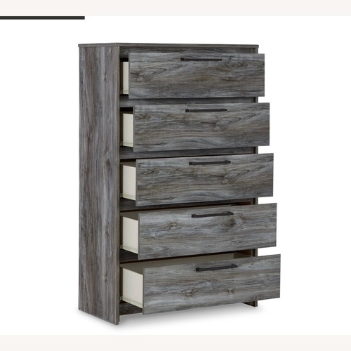 Used Ashley Baystorm Dark Gray Wood Chest for sale on AptDeco