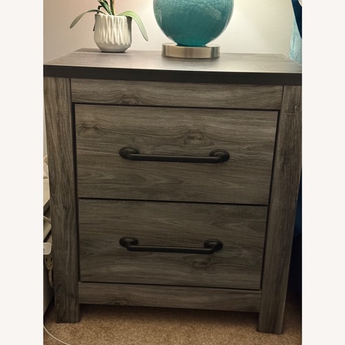 Used Ashley Furniture Dark Gray Wood Nightstand for sale on AptDeco