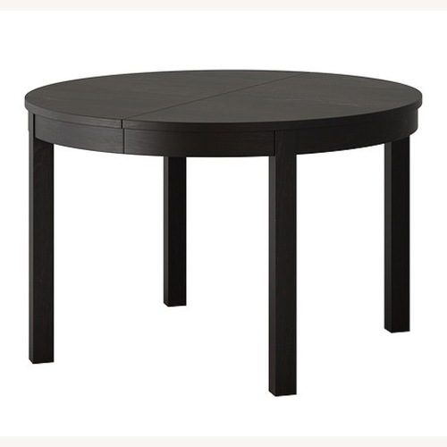 Used IKEA Bjursta Round Dining Table in Brown-Black for sale on AptDeco
