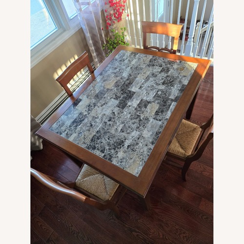 Used Dark Brown Wood Dining Table and Chairs for sale on AptDeco