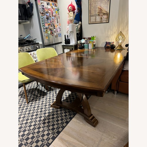 Used Raymour & Flanigan Dark Brown Solid Wood Expandable Dining Table for sale on AptDeco