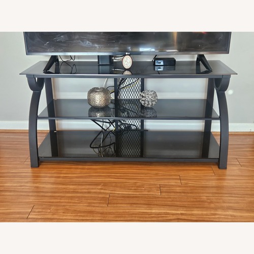 Used Black Glass TV Stand for sale on AptDeco