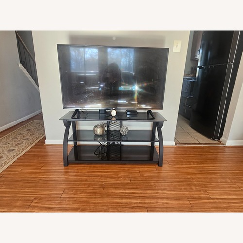 Used Black Glass TV Stand for sale on AptDeco
