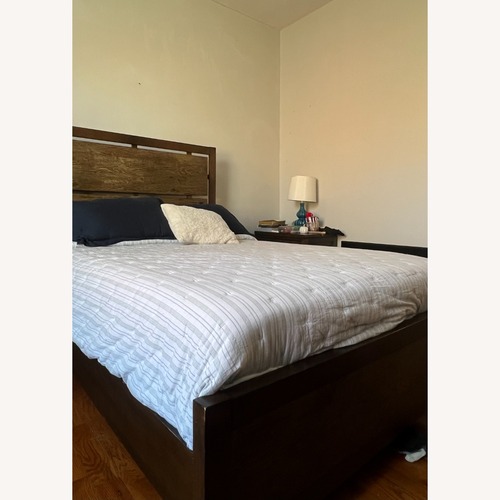 Used Raymour & Flanigan Dark Brown Wood Full Bed for sale on AptDeco