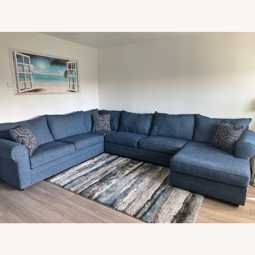 Used Juno Denim 142'' 4 Piece Chaise Sectional with Ottoman for sale on AptDeco