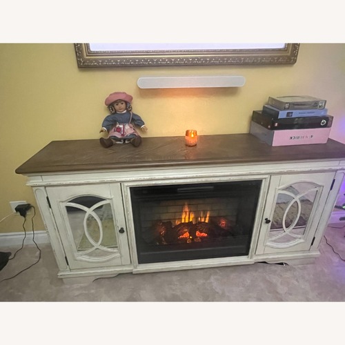 Used Ashley White Wood Media Stand with Electric Fireplace for sale on AptDeco