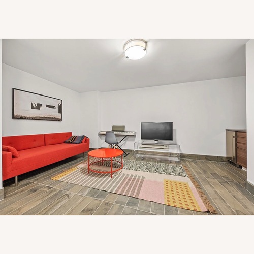 Used Room & Board Slim Red Metal Coffee Table for sale on AptDeco