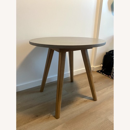 Used Article Atra Concrete and Acacia Dining Table for sale on AptDeco