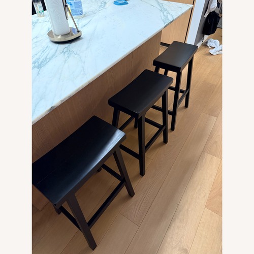 Used Pottery Barn Tibetan Black Wood Stools for sale on AptDeco