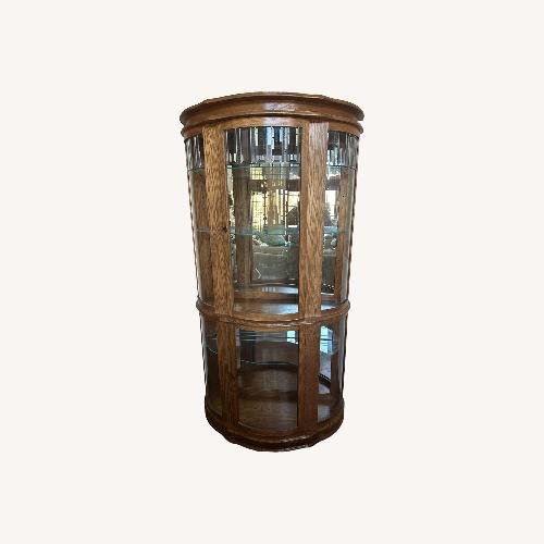 Used Lighted Oak Curio Cabinet W Glass Shelves for sale on AptDeco