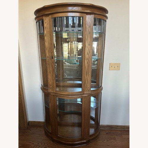 Used Lighted Oak Curio Cabinet W Glass Shelves for sale on AptDeco