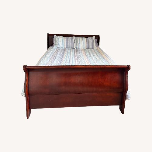 Used Dark Brown Wood Queen Bed for sale on AptDeco