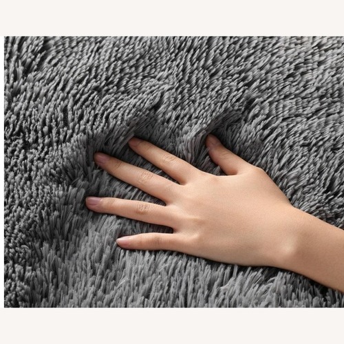 Used Dark Gray Fabric Area Rug 5' x 7' for sale on AptDeco