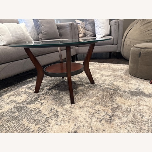 Used Raymour & Flanigan Dark Brown W Glass Top Coffee Table for sale on AptDeco