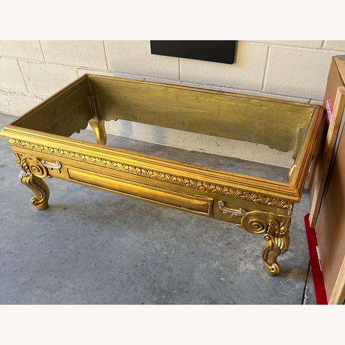 Used Gold Leaf Coffee Table with Tavertine Top for sale on AptDeco