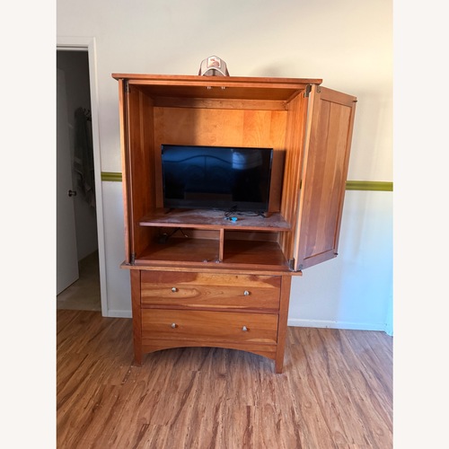 Used Dark Brown Wood Armoire for sale on AptDeco