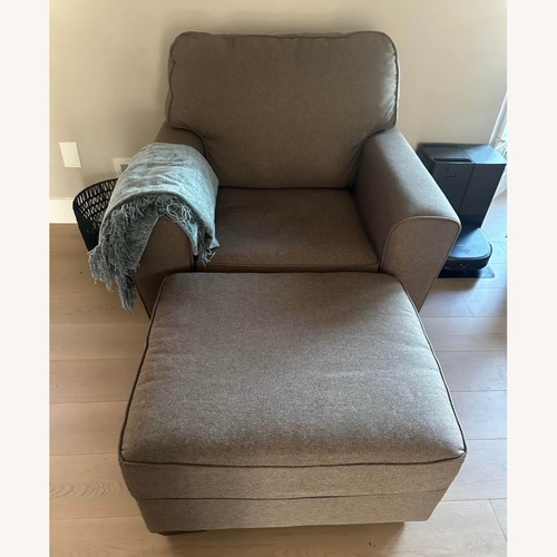 Used Ashley Furniture Dark Brown Armchair and Ottoman for sale on AptDeco