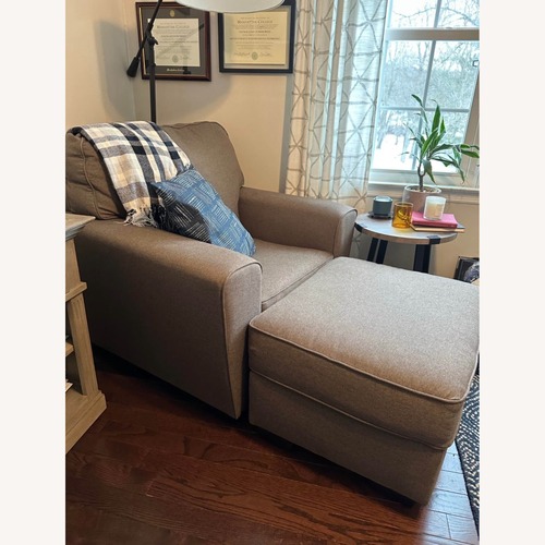 Used Ashley Furniture Dark Brown Armchair and Ottoman for sale on AptDeco