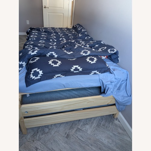 Used Yellow Wood Queen Bed for sale on AptDeco