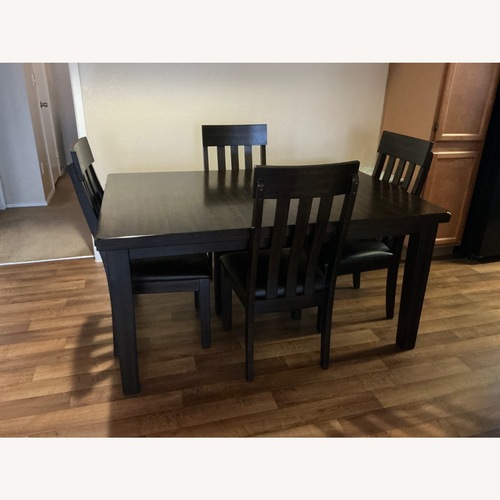 Used Ashley Furniture Haddigan Extendable Dining Table with Chairs for sale on AptDeco