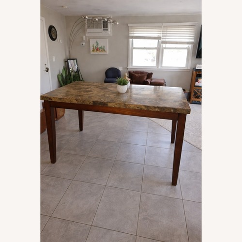 Used Dark Brown Dining Table for sale on AptDeco