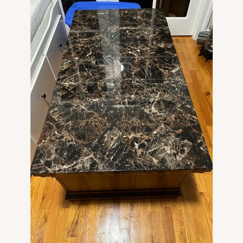 Used Ashley Furniture Kraleene Dark Brown Coffee Table for sale on AptDeco