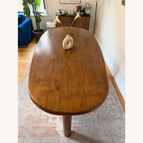 Used Calista Dark Brown Wood Dining Table for sale on AptDeco