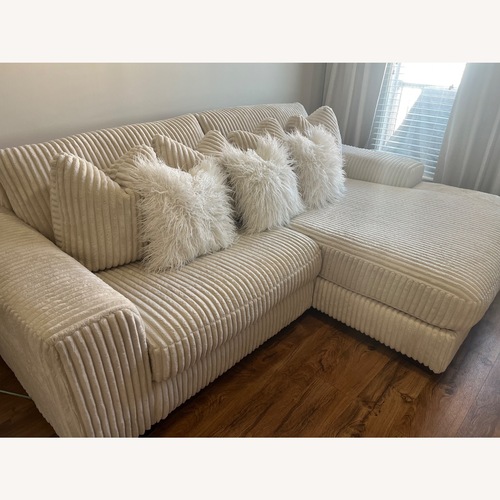Used Ashley Furniture Lindyn 2-Piece Modular Loveseat with Chaise - Ivory for sale on AptDeco