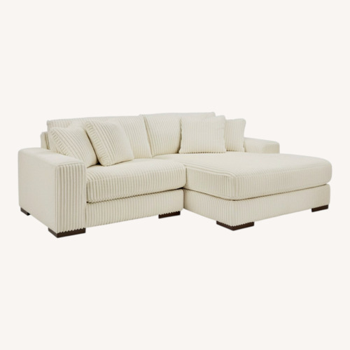 Used Ashley Furniture Lindyn 2-Piece Modular Loveseat with Chaise - Ivory for sale on AptDeco