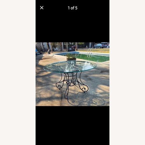 Used Glass Patio Table with Wrought Iron Legs for sale on AptDeco