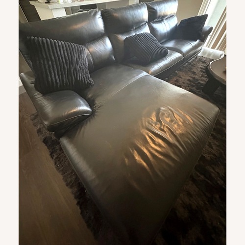 Used Black Leather 2 Piece Sectional for sale on AptDeco