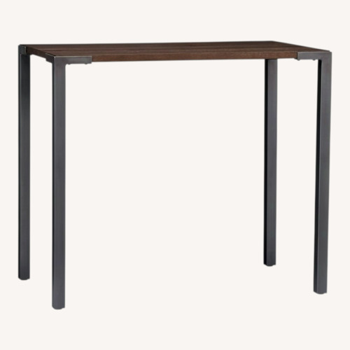 Used CB2 Stilt Dark Brown Wood Dining Table for sale on AptDeco