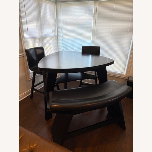 Used Dark Brown Wood Dining Table for sale on AptDeco