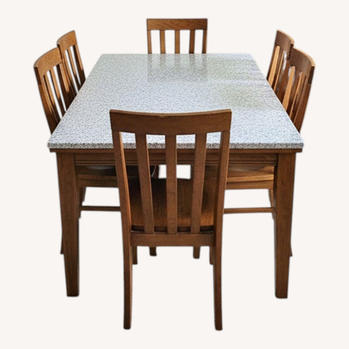 Used Granite Top Dining Table with 6 Worn Used Chairs  for sale on AptDeco