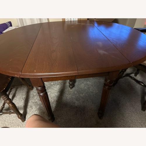 Used Dark Brown Wood Dining Table for sale on AptDeco