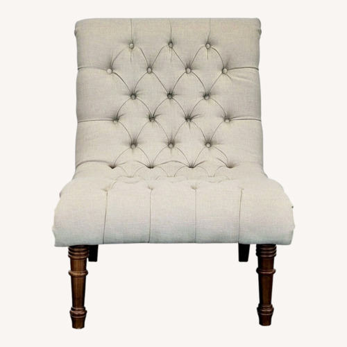 Used Beige Tufted Armless Lounge Chair with Wooden Legs for sale on AptDeco