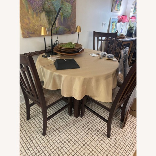 Used Dark Wood 5-Piece Round Extendable Dining Set for sale on AptDeco