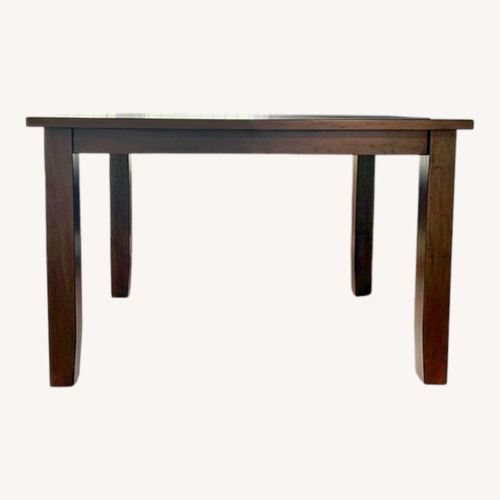 Used Raymour & Flanigan Light Brown Wood Dining Table for sale on AptDeco