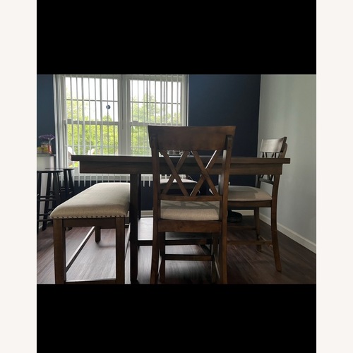 Used Raymour & Flanigan Light Brown Wood Dining Table for sale on AptDeco