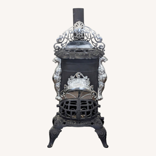 Used Vintage Iron Parlor Stove with Ornate Details for sale on AptDeco