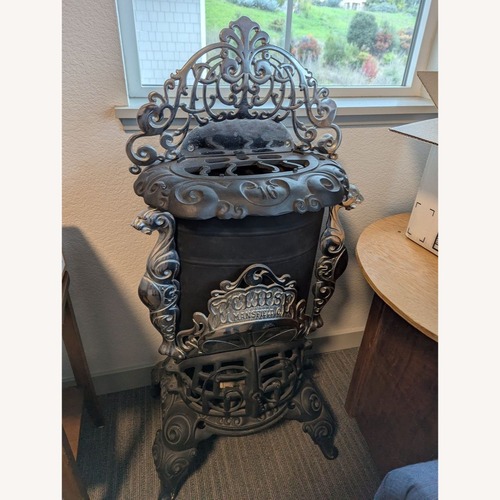 Used Vintage Iron Parlor Stove with Ornate Details for sale on AptDeco