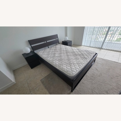 Used Dark Brown Wood Queen Bed for sale on AptDeco
