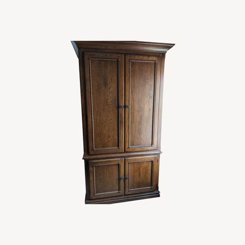 Used Dark Brown Wood Armoire for sale on AptDeco