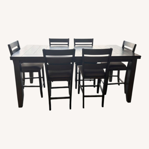 Used Living Spaces Dark Brown Wood Dining Set for sale on AptDeco