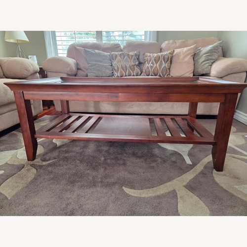 Used Living Spaces Dark Brown Wood Coffee Table for sale on AptDeco