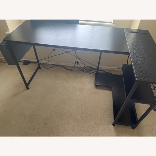 Used L- Shaped Black Wood Desk with Basket and Outlets for sale on AptDeco