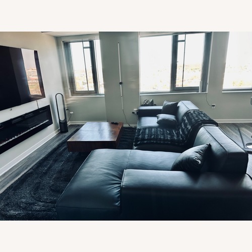 Used Black Leather 2 Piece Sectional for sale on AptDeco